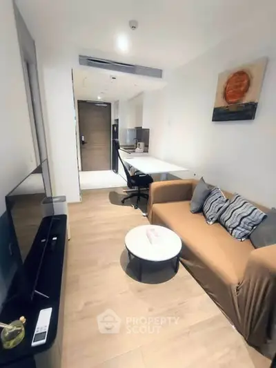 Modern living room with cozy sofa, TV, and stylish decor in a contemporary apartment.