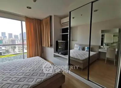 Modern bedroom with mirrored wardrobe and city view in high-rise apartment