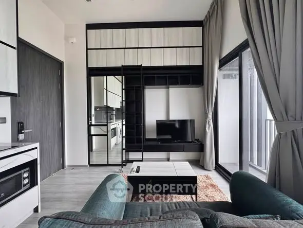 Modern living room with sleek furniture and balcony view