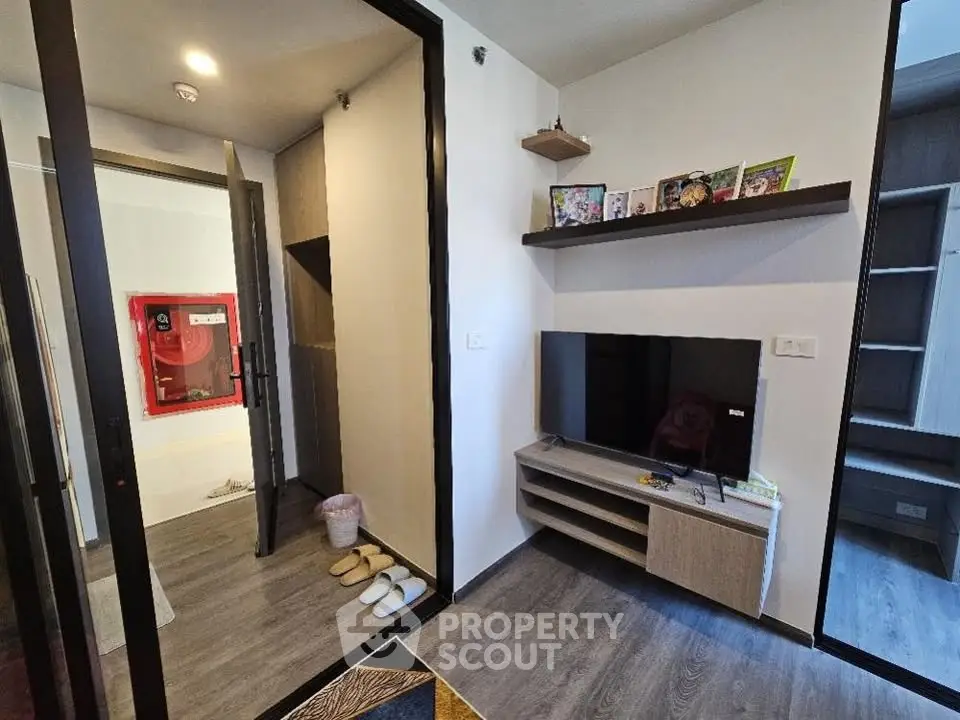 Modern living room with sleek TV stand and cozy decor in a stylish apartment.
