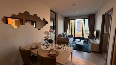 Modern living room with dining area and city view, featuring stylish decor and natural light.