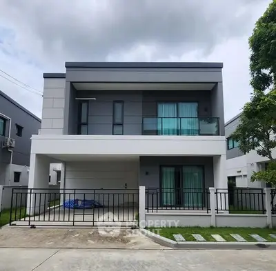 Modern two-story house with sleek design and spacious driveway