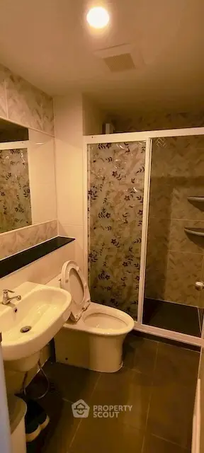 Modern bathroom with shower enclosure and stylish tile design.