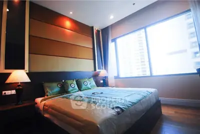 Luxurious bedroom with large window and modern decor in high-rise apartment.