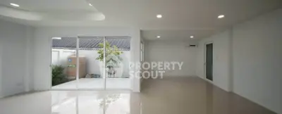 Spacious modern living room with large windows and garden view