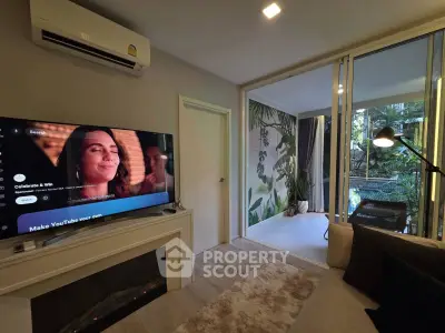 Modern living room with TV, air conditioning, and balcony view