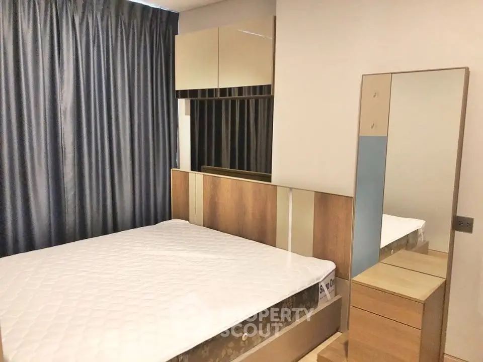 Modern bedroom with stylish furniture and large mirror