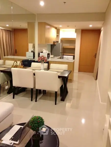 Modern open-plan living and dining area with sleek kitchen design