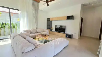 Spacious modern living room with large windows and stylish furniture