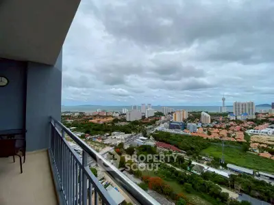 Stunning high-rise balcony with panoramic city and sea views.