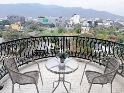 Stunning balcony view with cityscape and mountains, perfect for relaxation and enjoying the scenery.