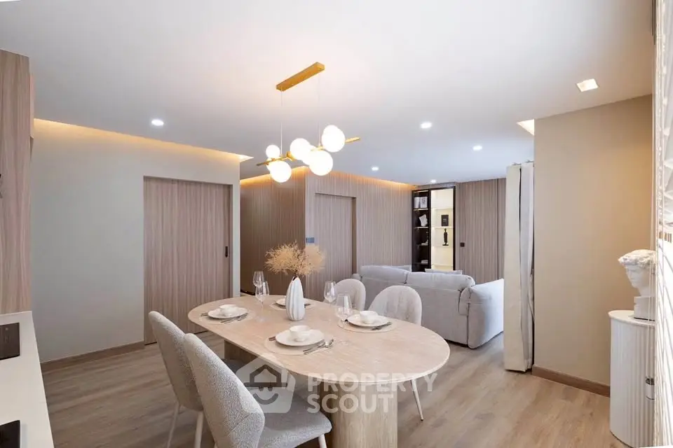 Modern open-plan living and dining area with stylish decor and elegant lighting