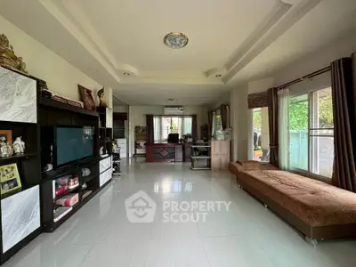 Spacious living room with modern decor and large windows for natural light.