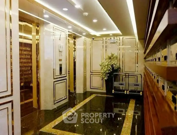 Luxurious building entrance with elegant decor and polished floors.