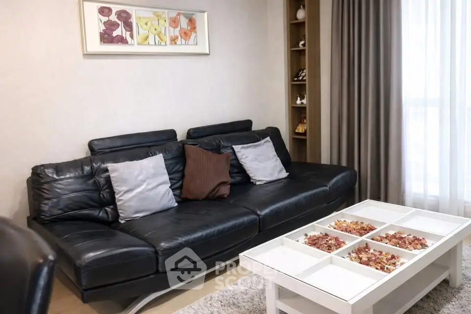 Stylish living room with black leather sofa and modern decor