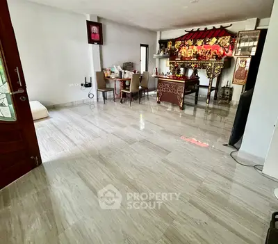 Spacious living room with elegant marble flooring and traditional decor
