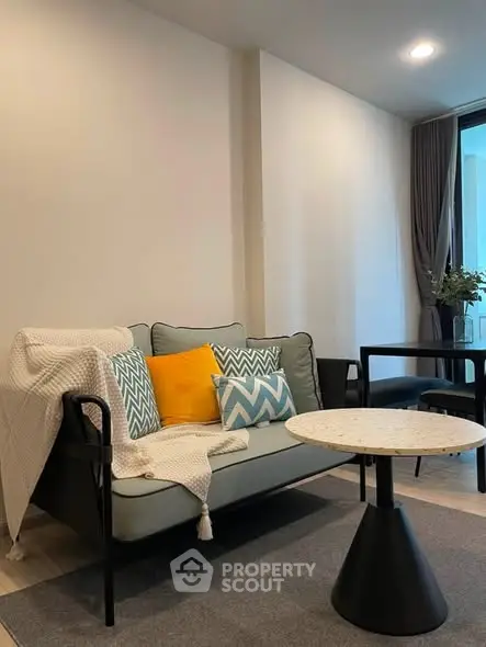 Modern living room with stylish sofa and chic decor in a cozy apartment setting.