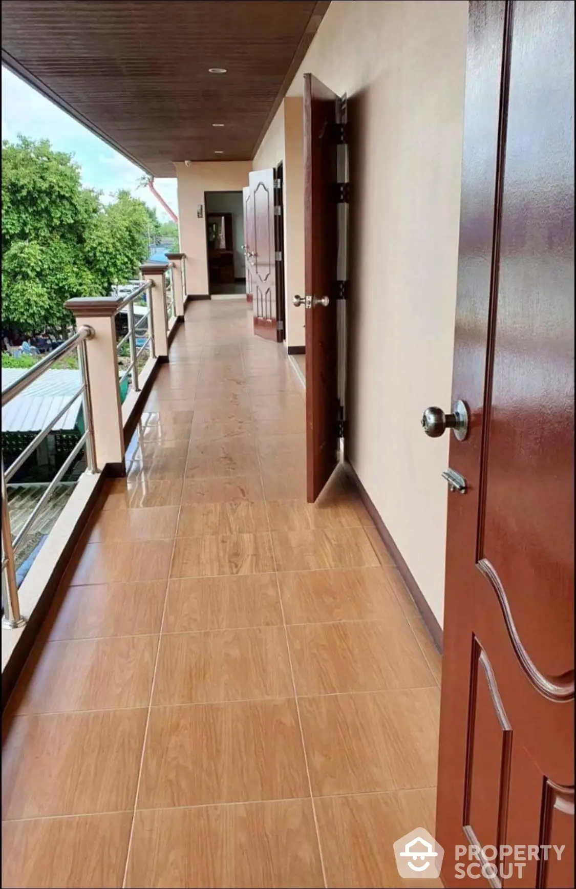 Spacious balcony with elegant wood-finished ceiling and tiled flooring, offering a serene outdoor extension to the living space.