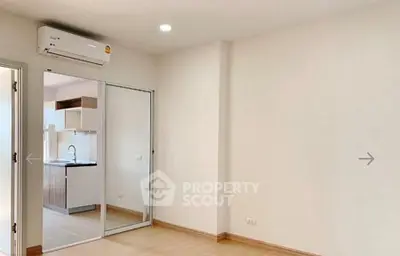Modern apartment interior with open layout and sleek kitchen design.
