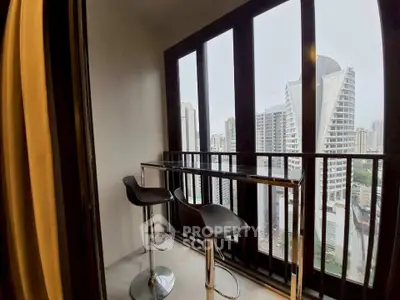Modern balcony with city view and stylish bar stools in high-rise apartment.
