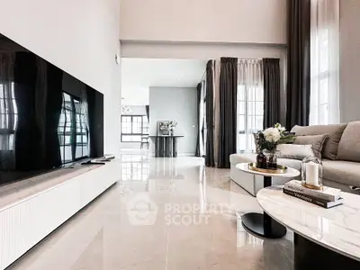Spacious modern living room with sleek design and large windows