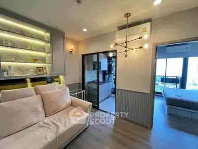 Modern apartment interior with cozy living room and open kitchen layout, featuring stylish lighting and decor.