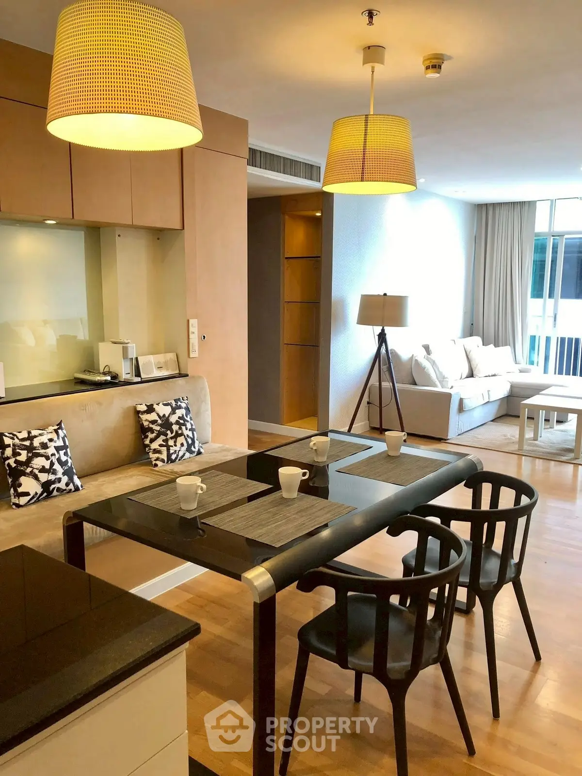 Modern open-plan living room with stylish dining area and cozy seating, perfect for urban living.