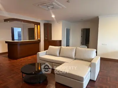 Spacious living room with elegant wooden flooring and modern furniture
