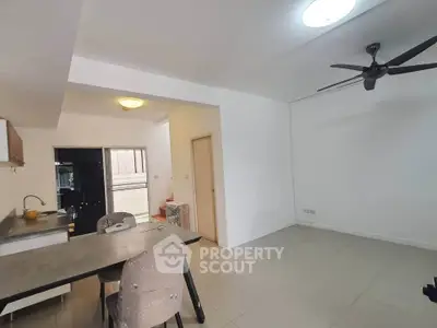 Spacious modern living area with open layout and ceiling fan