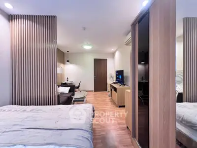 Modern studio apartment with stylish wooden accents and cozy living area.