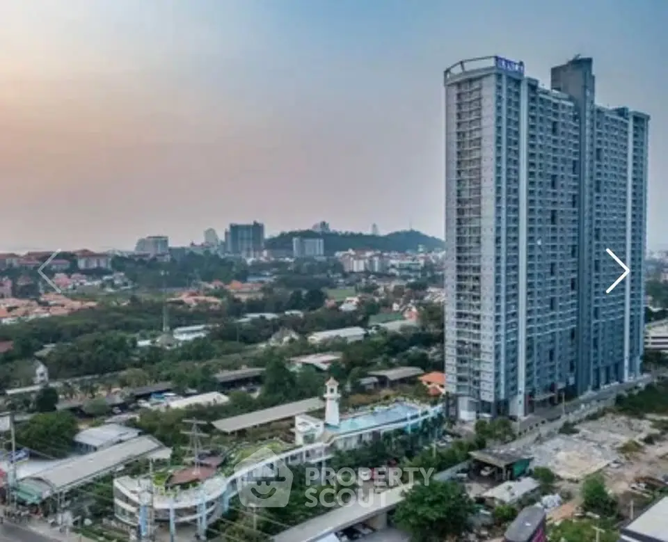 Stunning high-rise building with panoramic city views and lush surroundings.