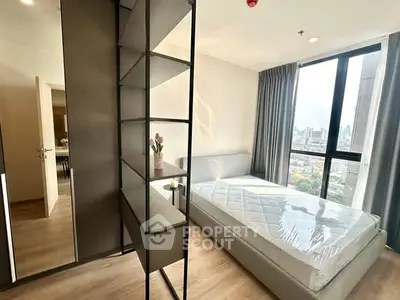 Modern bedroom with large window and city view, featuring minimalist design and natural light.