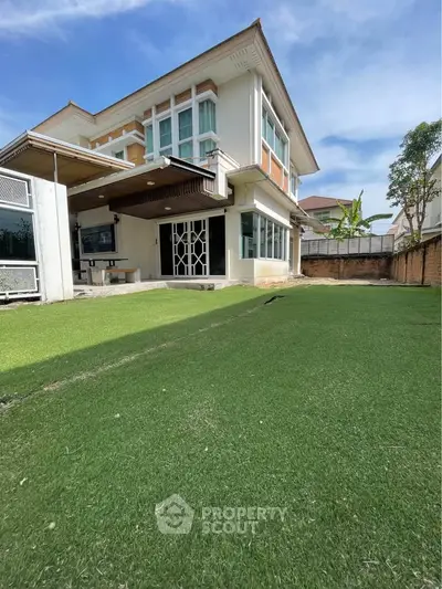 Spacious modern house with lush green lawn and elegant architecture, perfect for family living.
