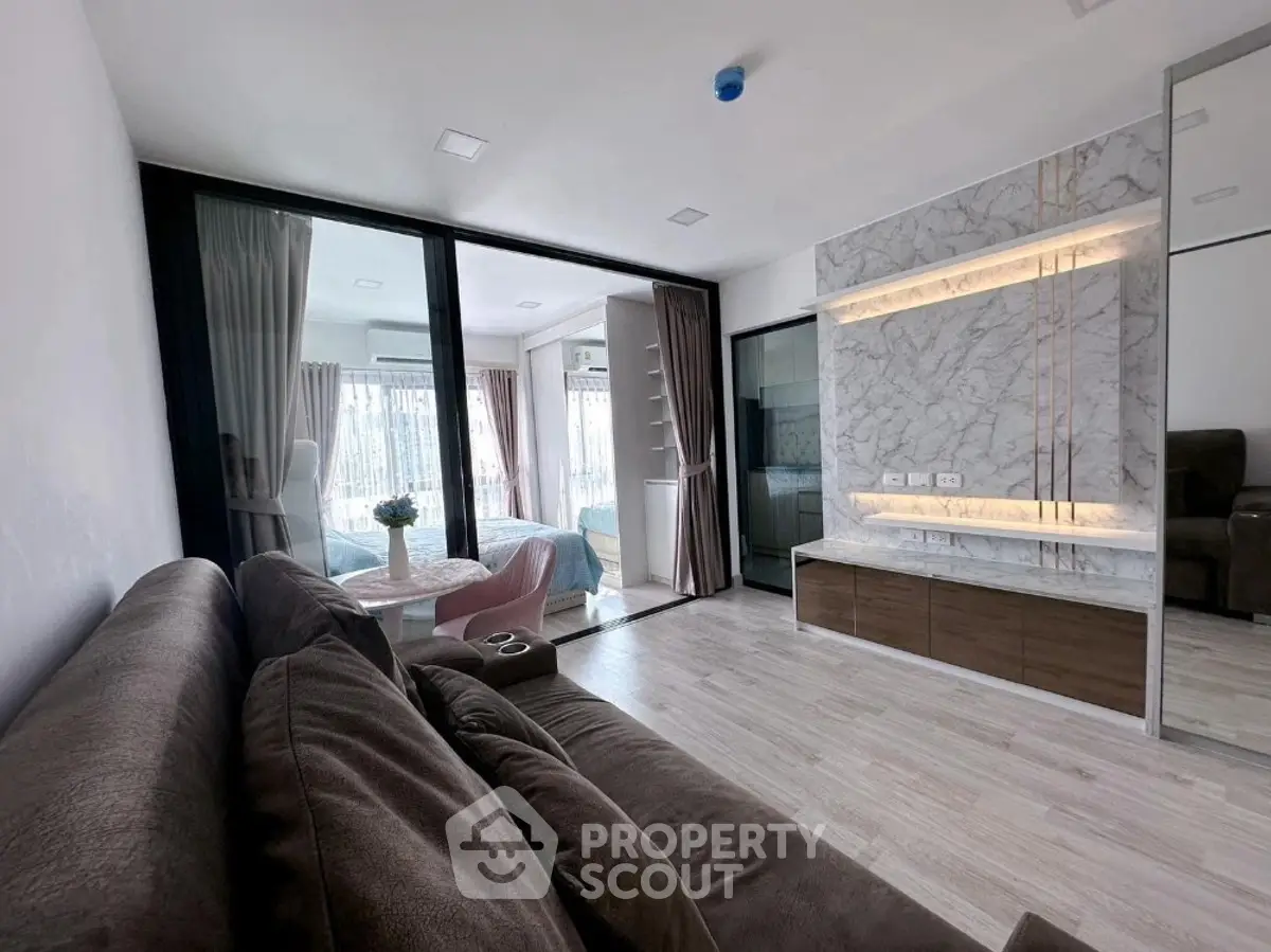 Modern living room with elegant marble wall and cozy seating area