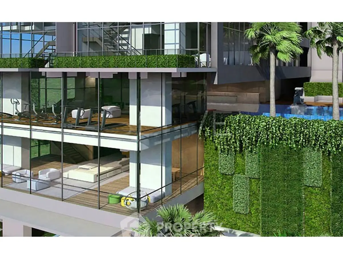 Luxurious modern building with glass facade, gym, and pool surrounded by lush greenery.