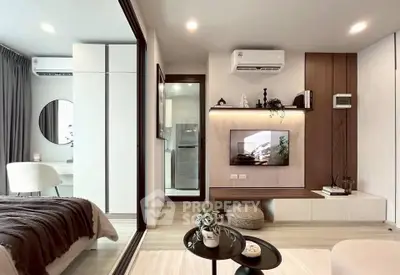 Modern living room with stylish decor and open layout, featuring air conditioning and sleek furniture.