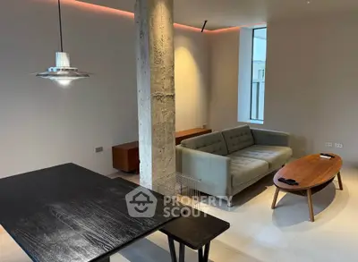 Modern living room with stylish furniture and unique architectural column