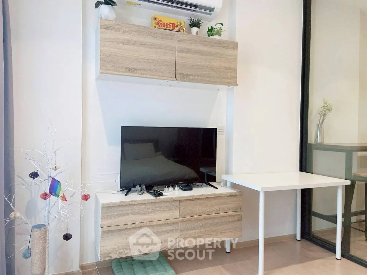 Modern living room with sleek TV setup and stylish wooden cabinets