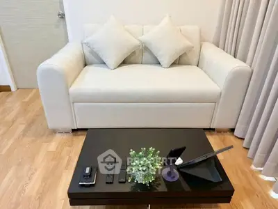 Cozy living room with modern sofa and sleek coffee table in stylish apartment.