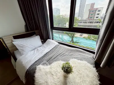 Cozy bedroom with pool view in modern apartment