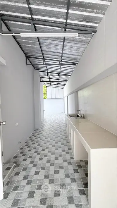 Modern open-layout kitchen with sleek countertops and tiled flooring