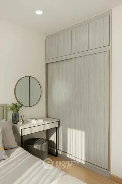 Modern bedroom with sleek wardrobe and stylish vanity area