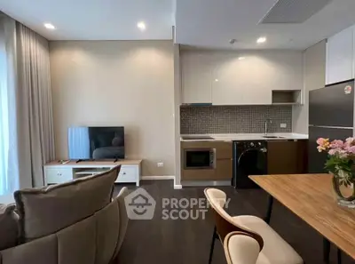 Modern open-plan living room with sleek kitchen and stylish furniture