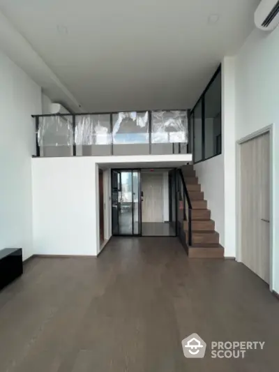 Spacious modern loft with mezzanine and sleek wooden staircase