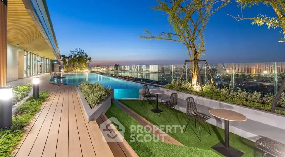 Luxurious rooftop pool with stunning city view and modern seating area at sunset.