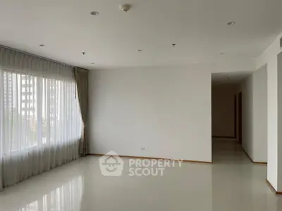 Spacious empty living room with large window and natural light