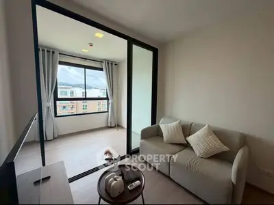 Modern living room with cozy sofa and large window offering city view