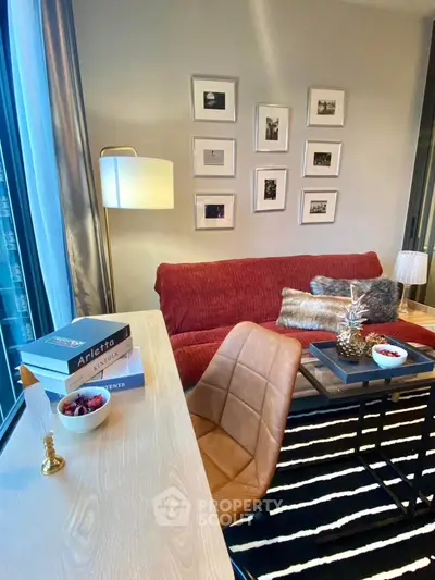 Stylish living room with modern decor, cozy red sofa, and elegant wall art.