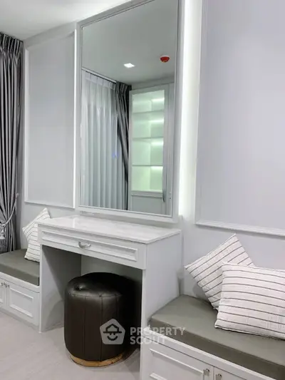 Elegant modern bedroom with stylish vanity and seating area