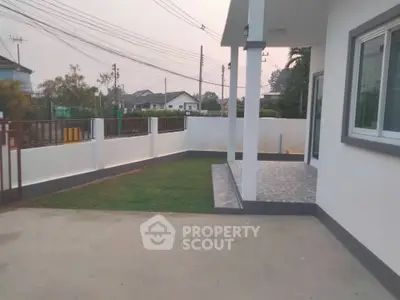 Charming suburban home with spacious yard and modern exterior design.